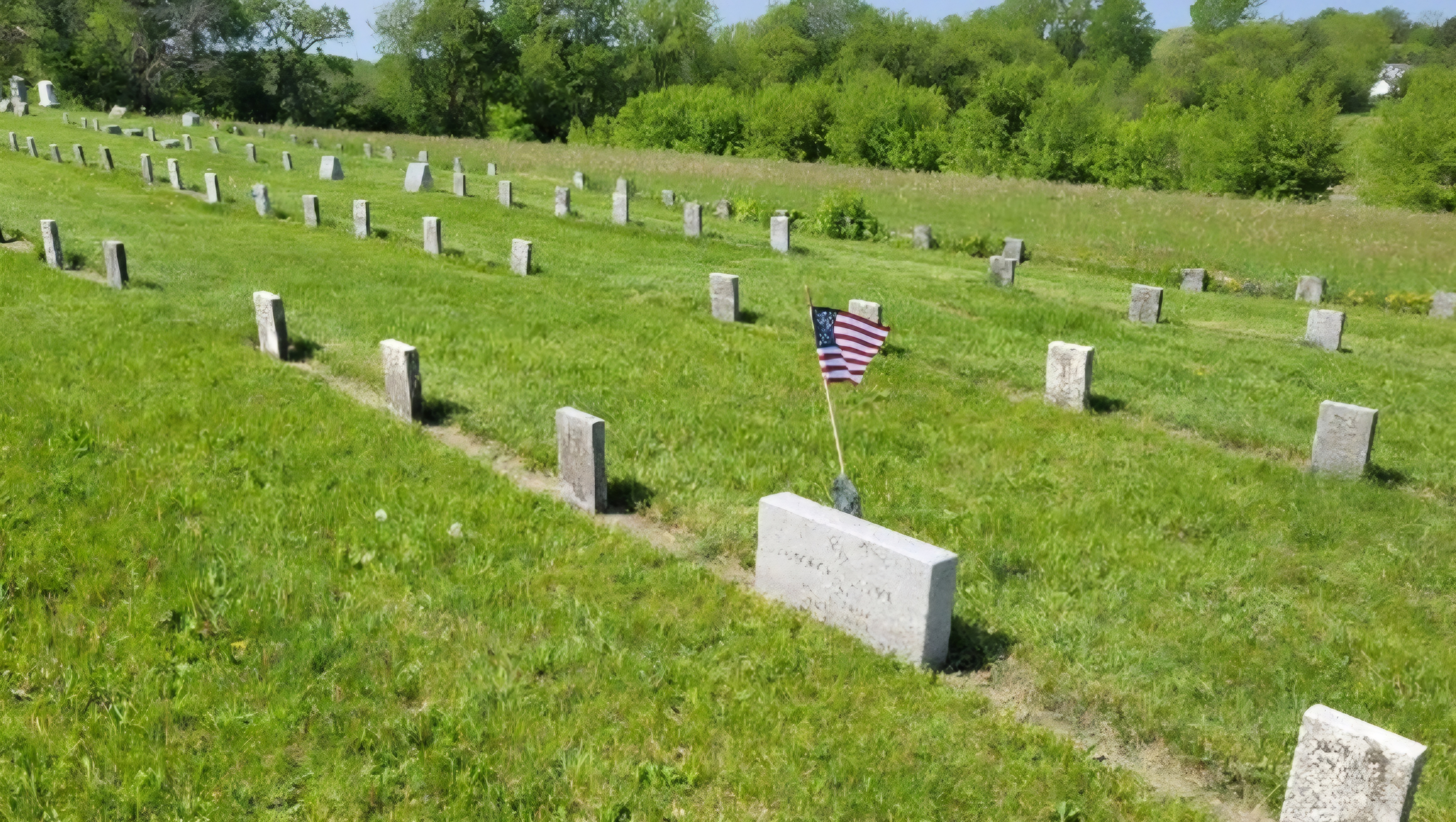 A flag waves at the grave of George Henke in the Bethesda section of the Lutheran cemetery.